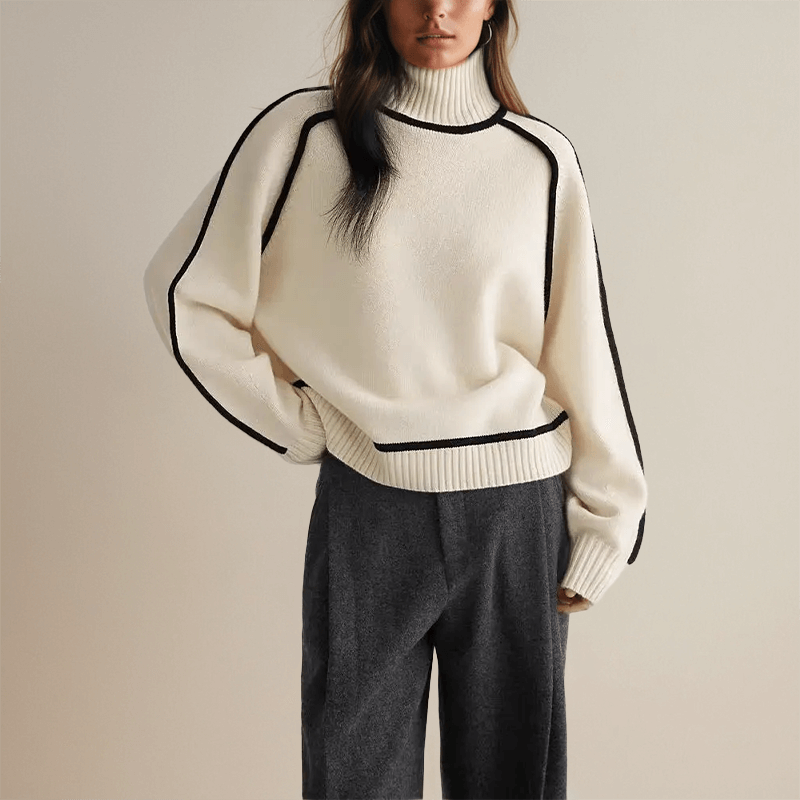 Oversized knit turtleneck sweater for women with wide sleeves and relaxed silhouette, side view