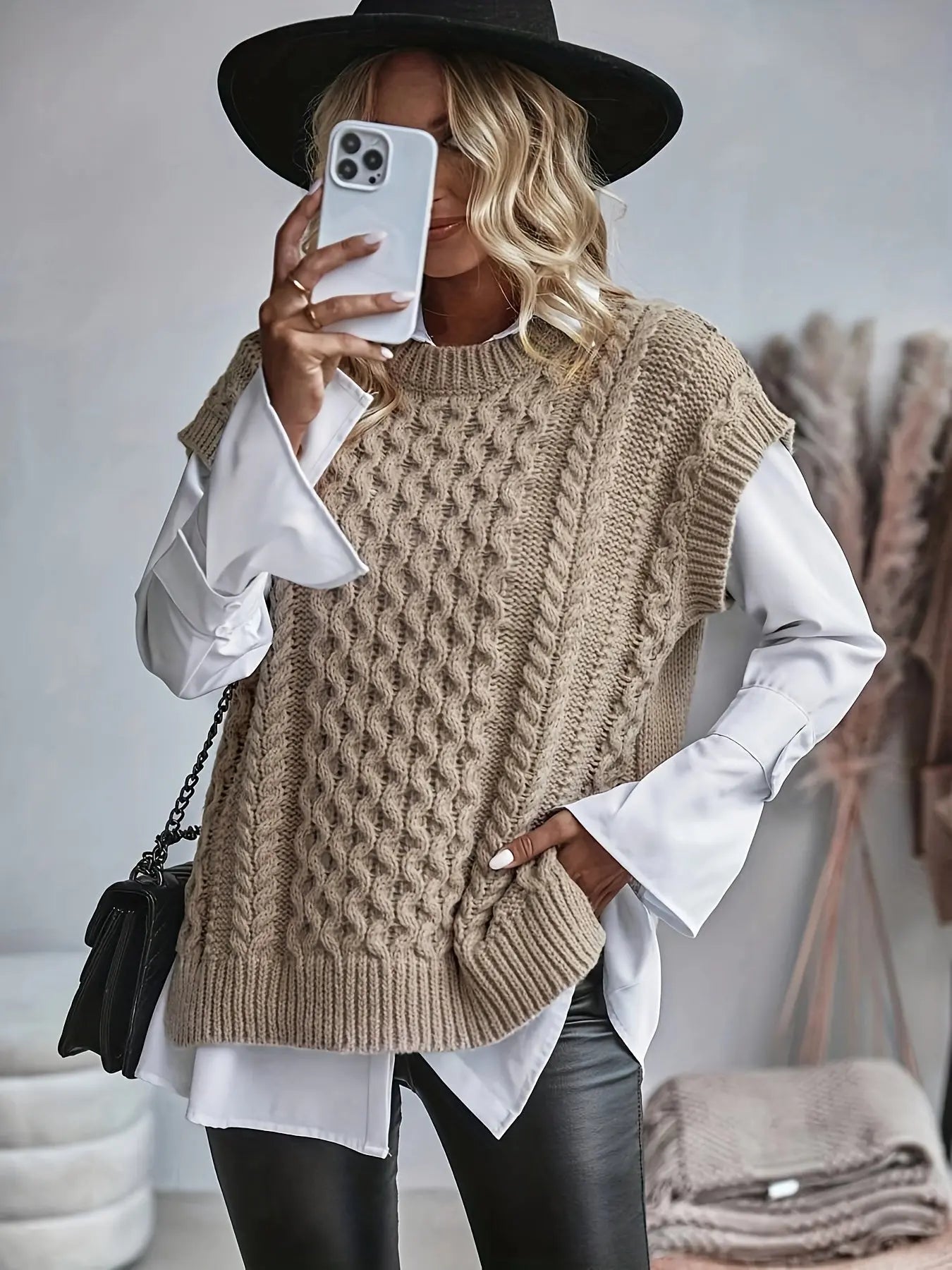 Women's cable knit sleeveless sweater with ribbed hem and relaxed fit, front view