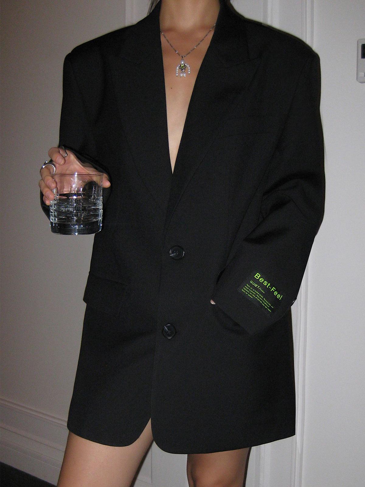 Women's oversized blazer coat worn as a complete outfit, full-length lifestyle view