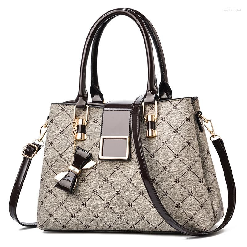 Women's structured patterned handbag with double top handles and glossy flap detail