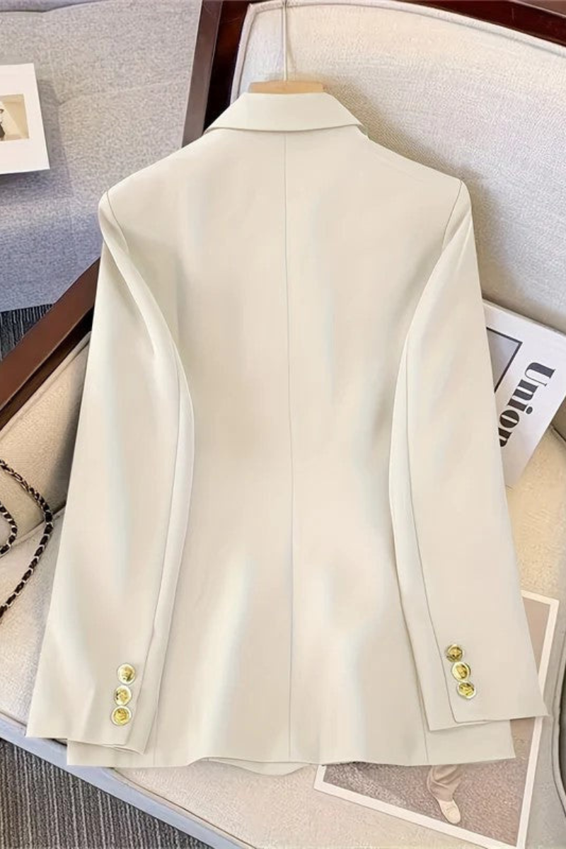 Women's polyester blazer with decorative metal buttons and welt pockets, close-up detail