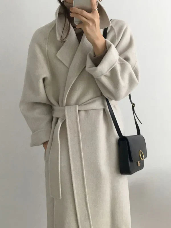 Long polyester women's coat with waist belt, three-quarter view