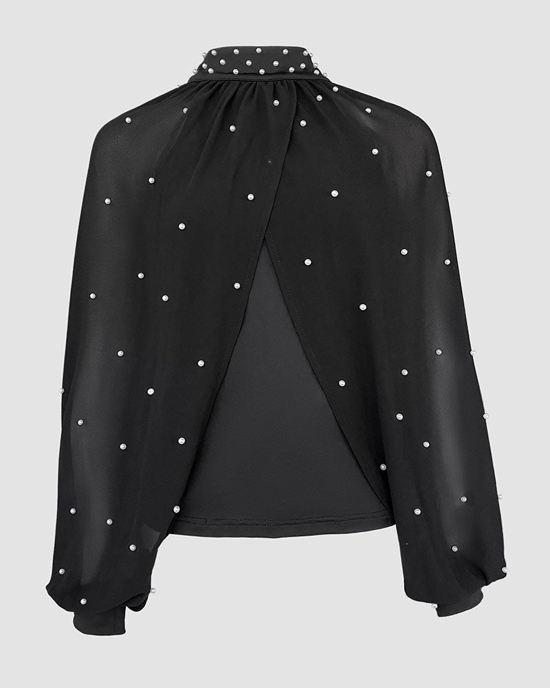 Detail shot of lightweight woven synthetic fabric on women's transparent long-sleeve blouse
