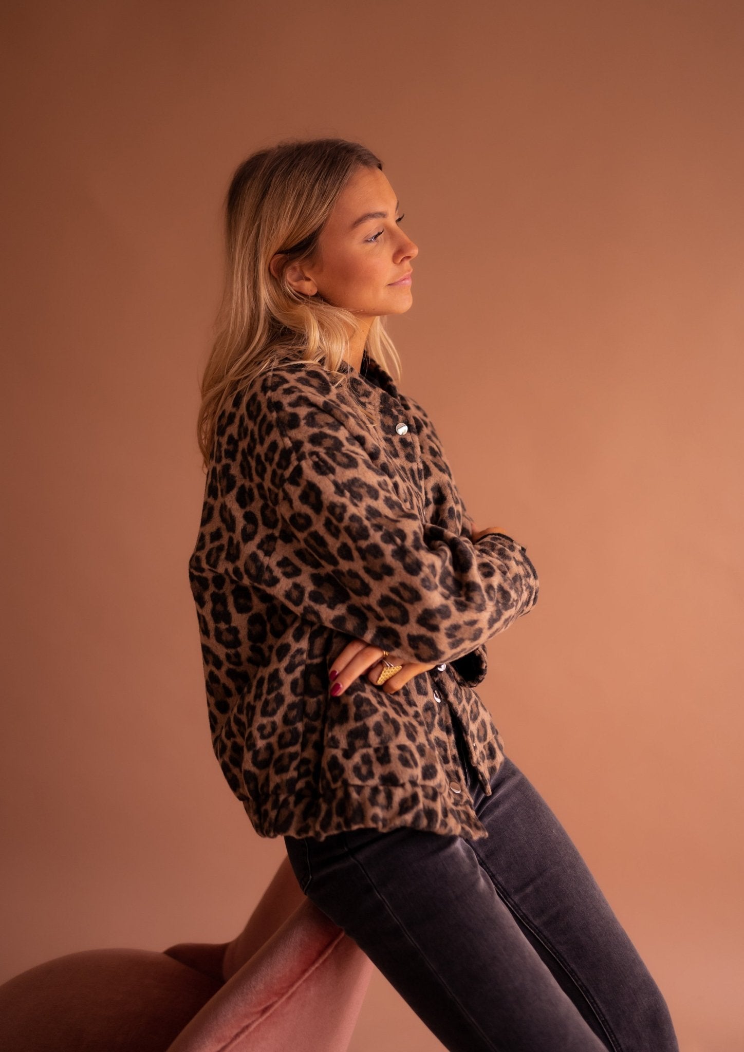 Close-up of women's leopard print jacket snap button closure and collar