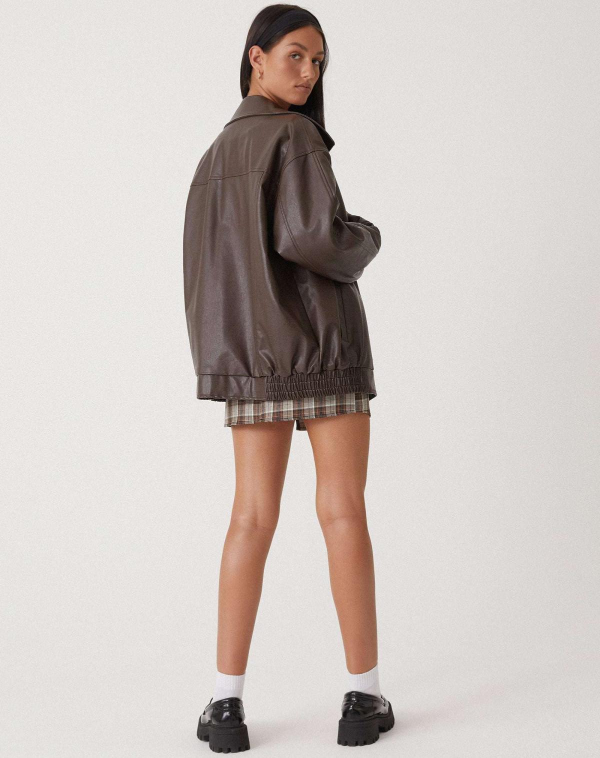 Back view of women's oversized vegan leather jacket with hip-length hem and relaxed fit