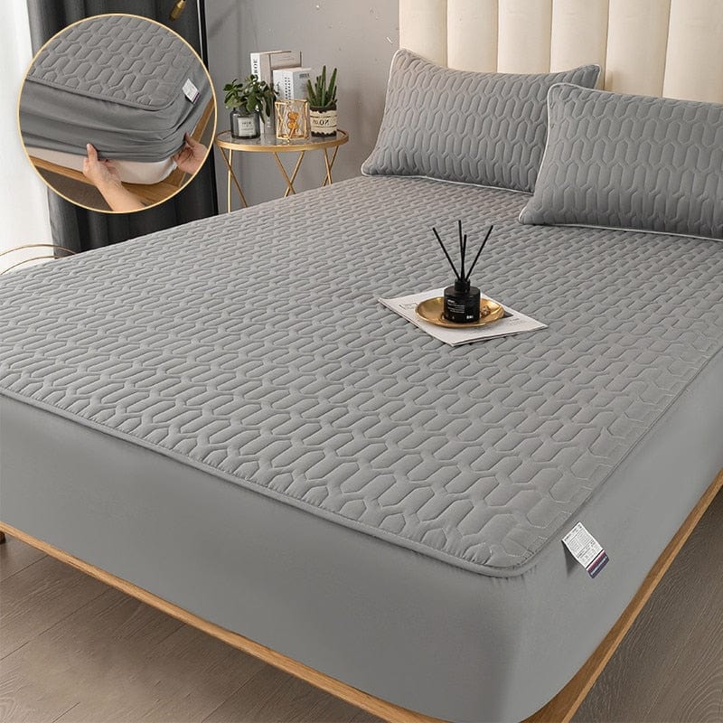 Quilted mattress protector with elastic edge fitted over a mattress