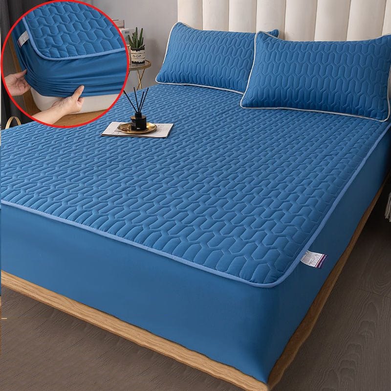 Top-down view of quilted mattress protector covering a full mattress surface