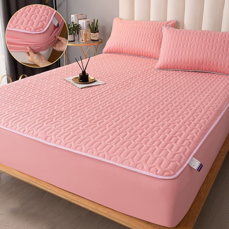 Packaged quilted mattress protector showing product label and size information