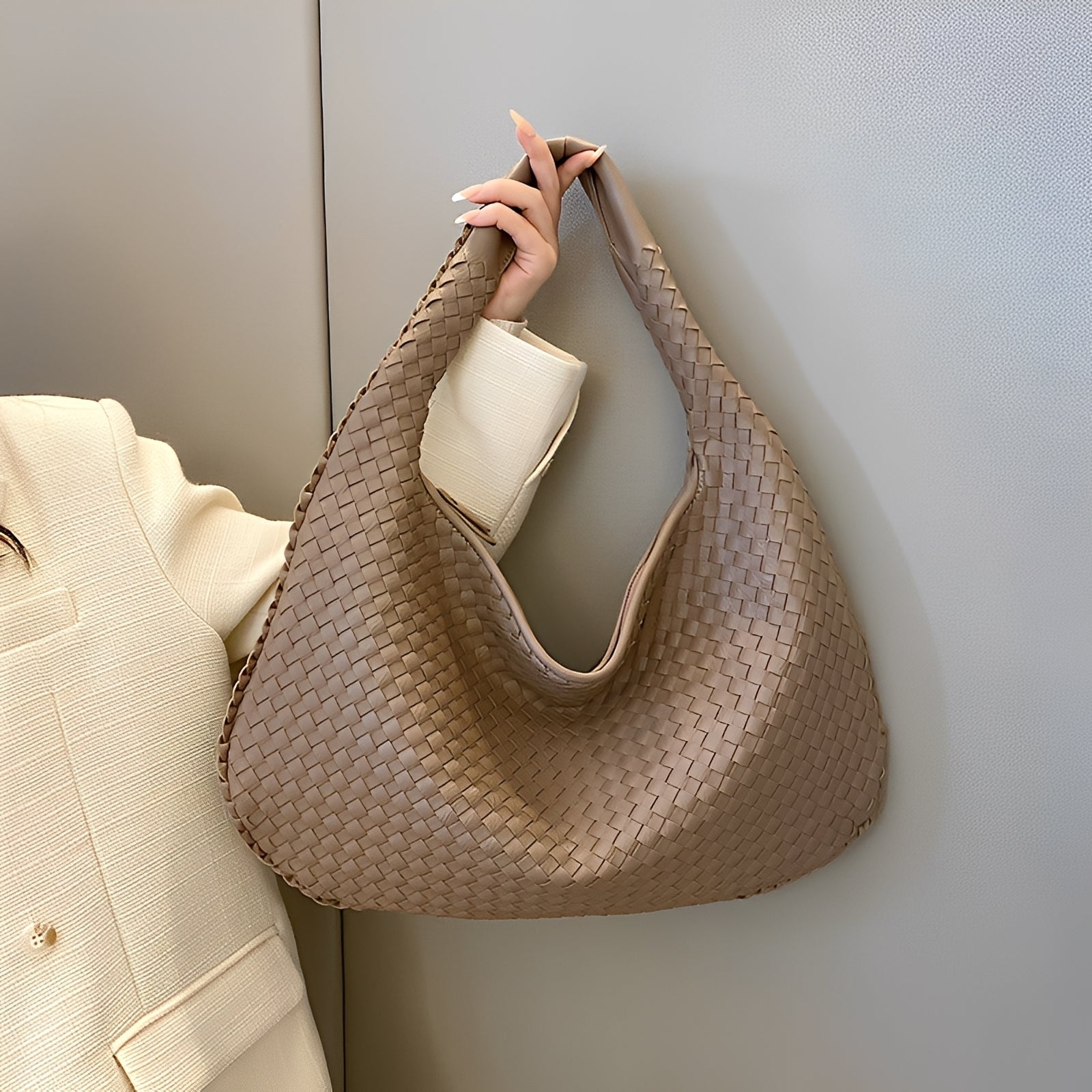 Women's woven shoulder bag with zipper top, angled view showing bag depth and shape