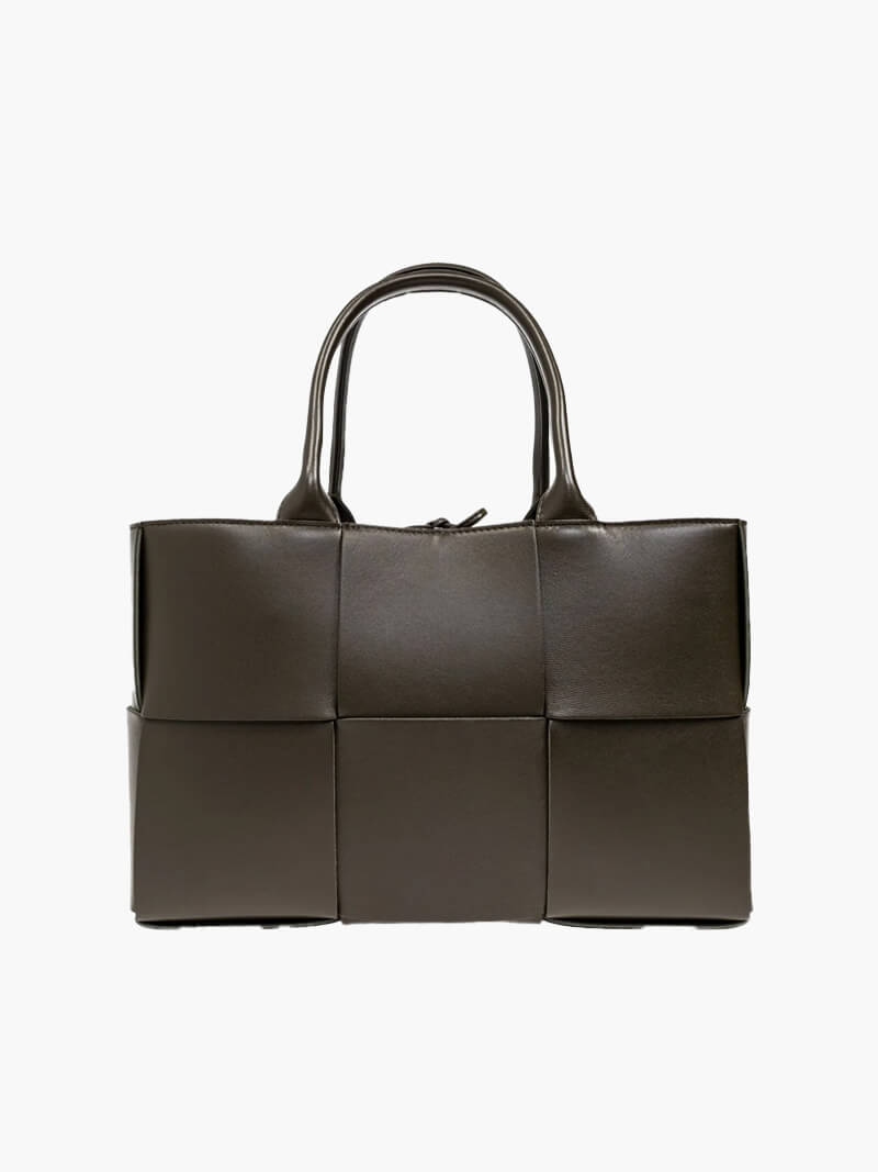 Structured woven tote bag with faux leather finish and zippered closure