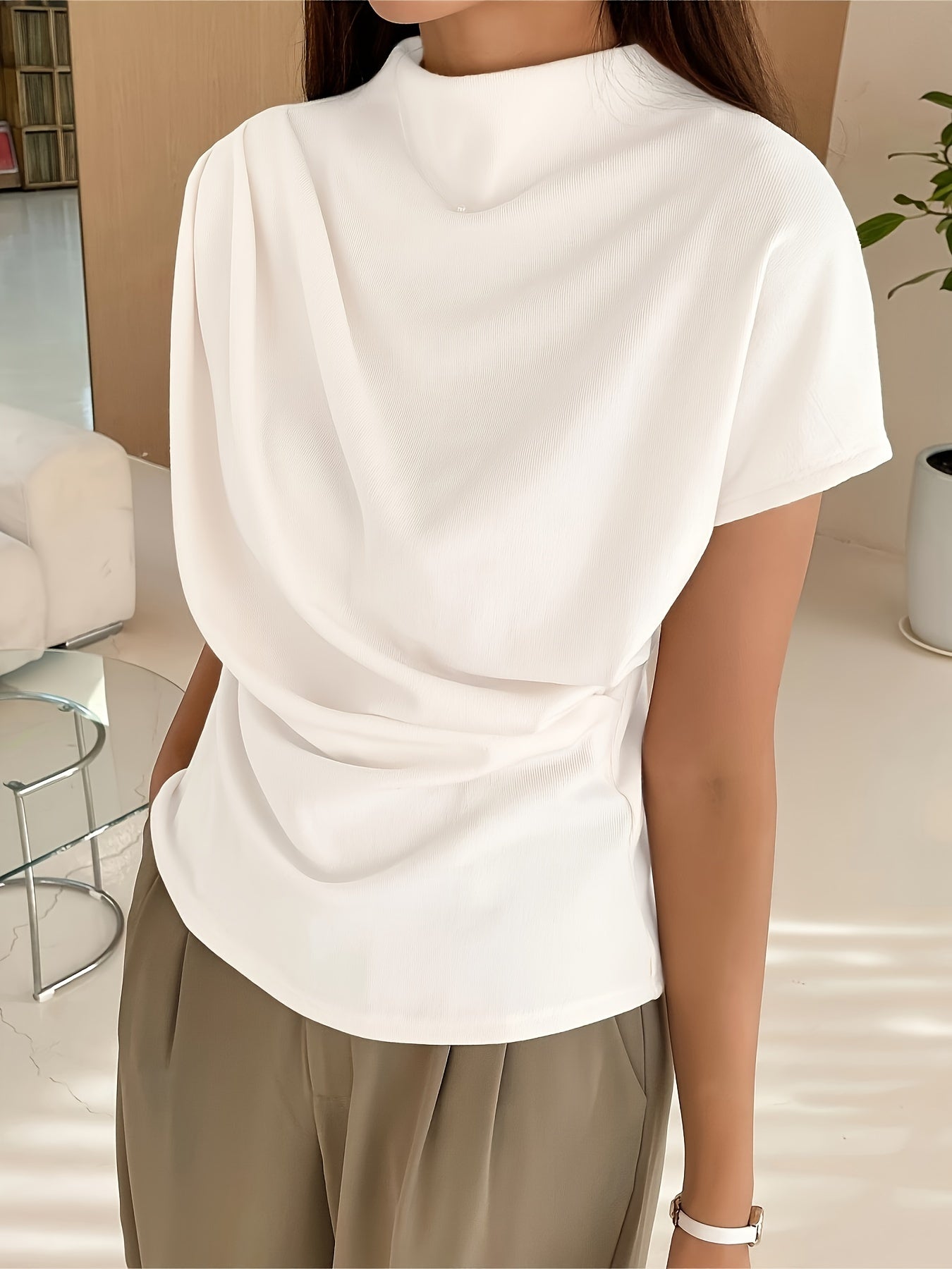 Short sleeve draped top with relaxed silhouette and smooth fabric surface