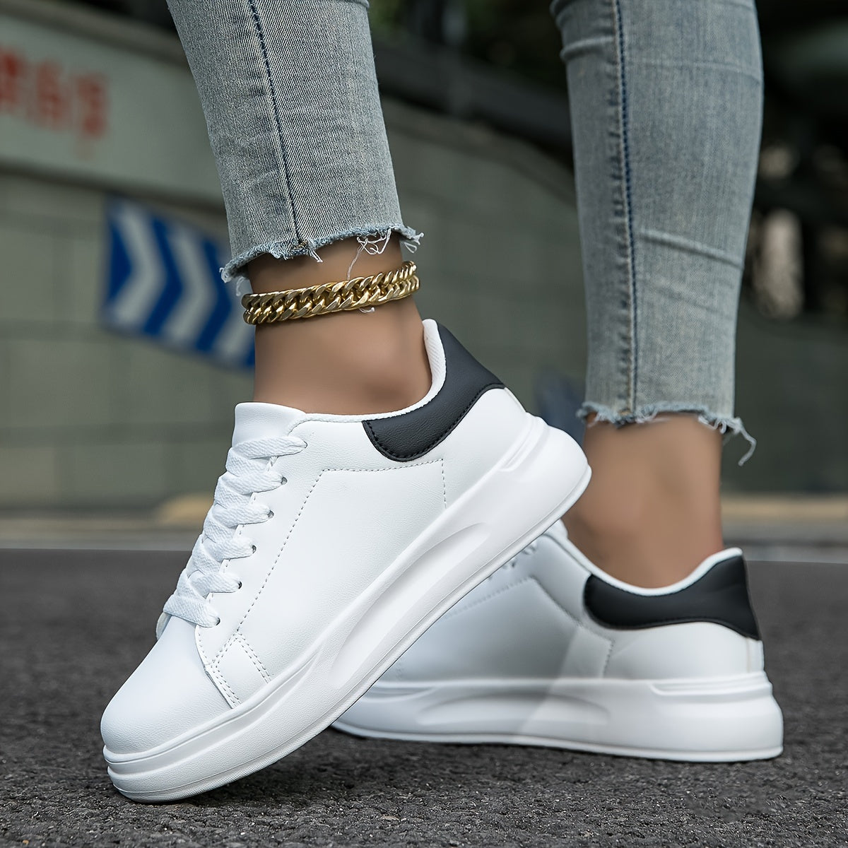 Close-up of women's sneaker toe box and lace detail on synthetic leather upper