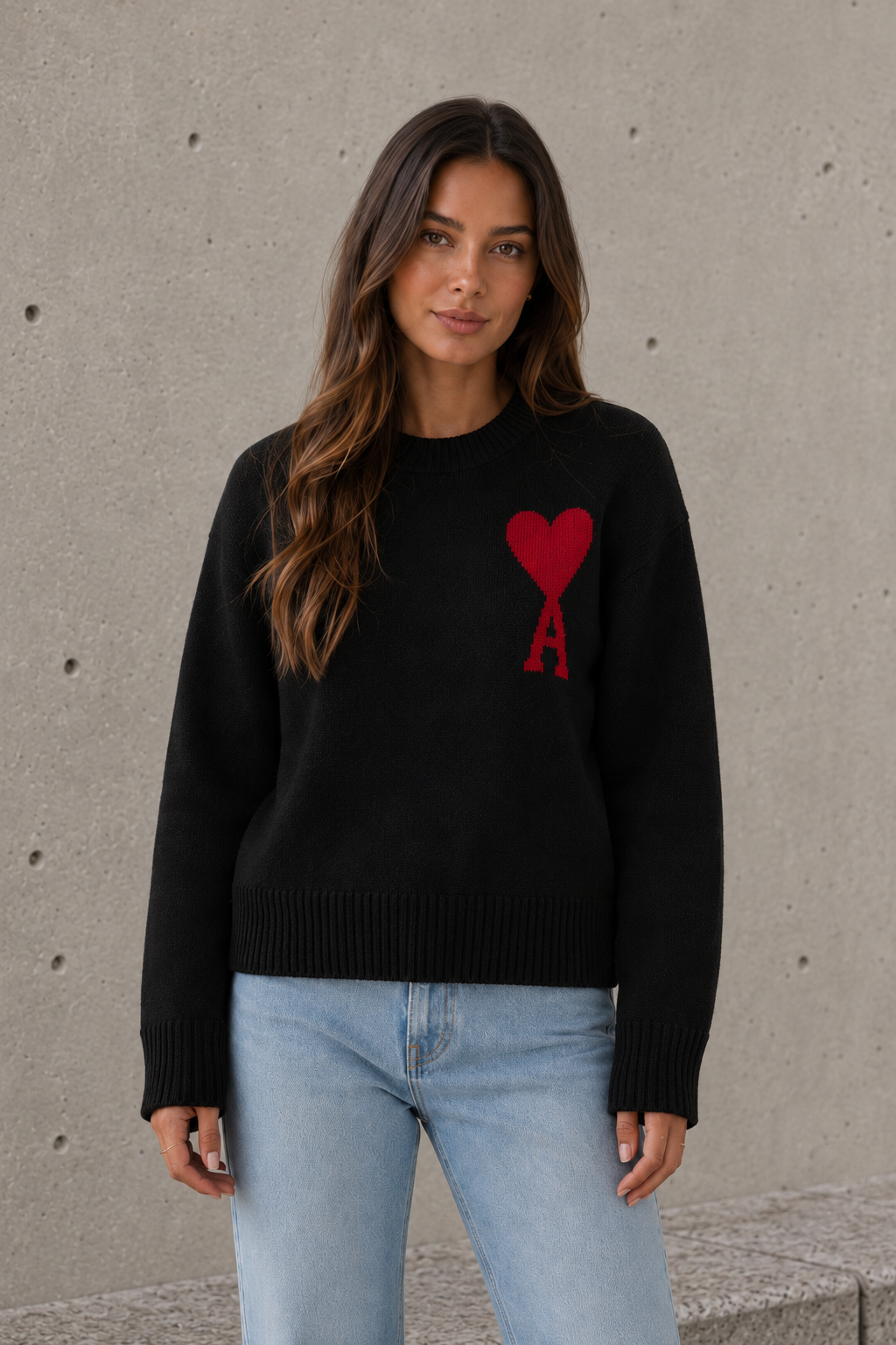 Women's black oversized sweater with heart and letter detail styled outdoors
